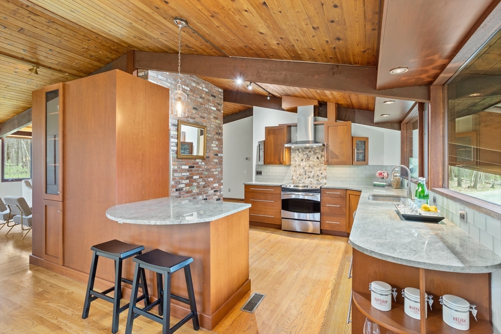 69 Long Ridge Road Carlisle, MA 01741 - Photo 9 of 42 a dining table with chairs and a table