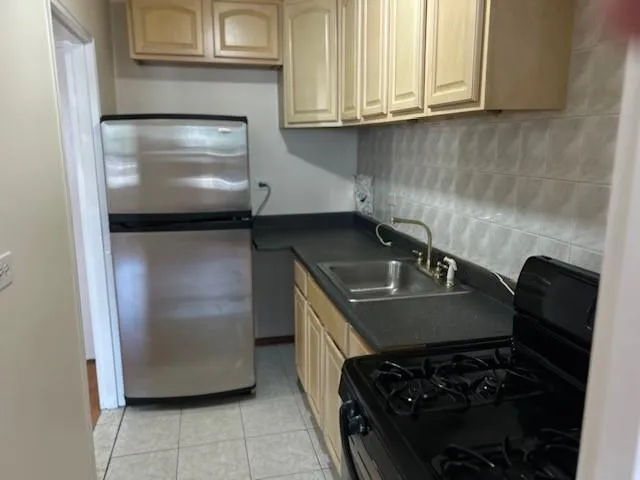 a kitchen with granite countertop a stove and a refrigerator