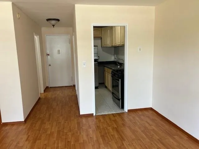 a view of a kitchen from a hallway