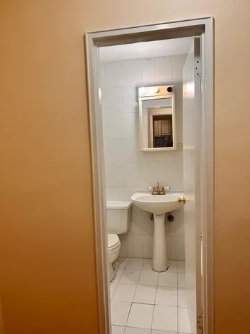 a bathroom with a sink a toilet and mirror
