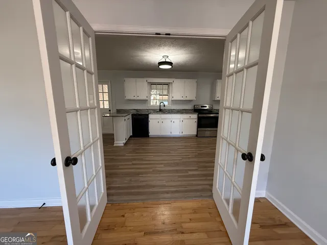 a view of a room with wooden floor and windows