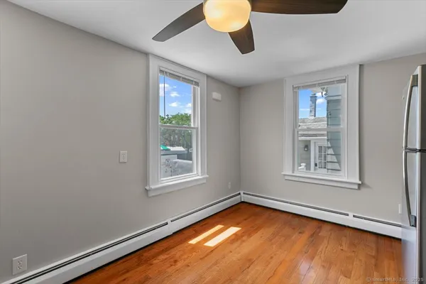 a view of a room with window and wooden floor