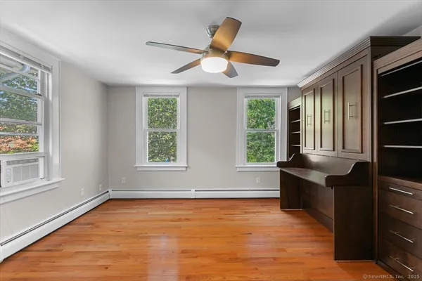a room with window and ceiling fan