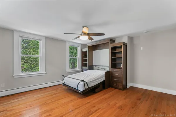 a spacious bedroom with a bed and window