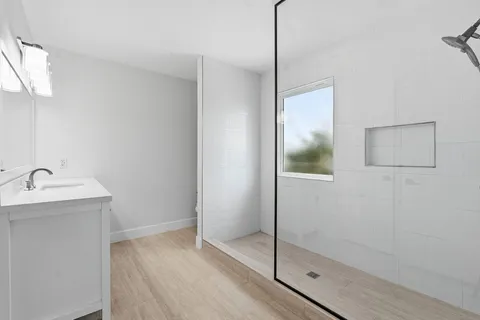 a bathroom with a sink vanity and a mirror
