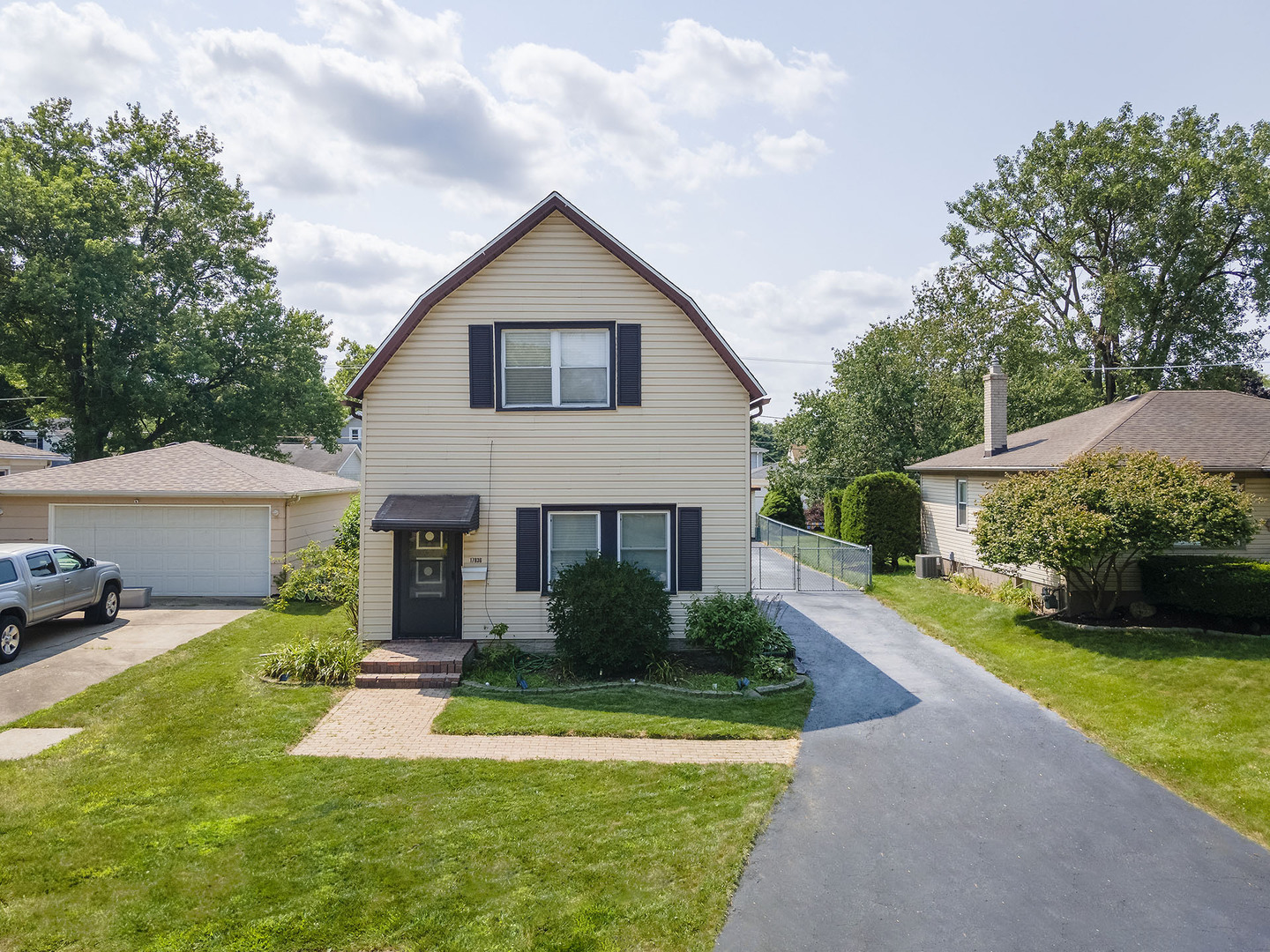 17836 Wildwood Avenue Lansing, IL 60438 - Photo 1 of 22 a front view of a house with a yard and garage