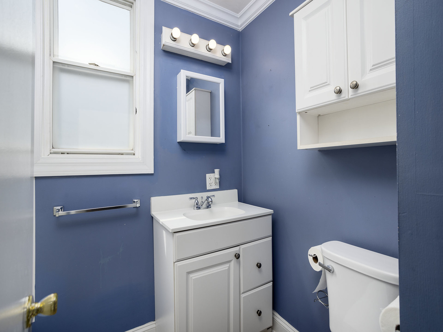 17836 Wildwood Avenue Lansing, IL 60438 - Photo 13 of 22 a bathroom with a toilet sink and mirror