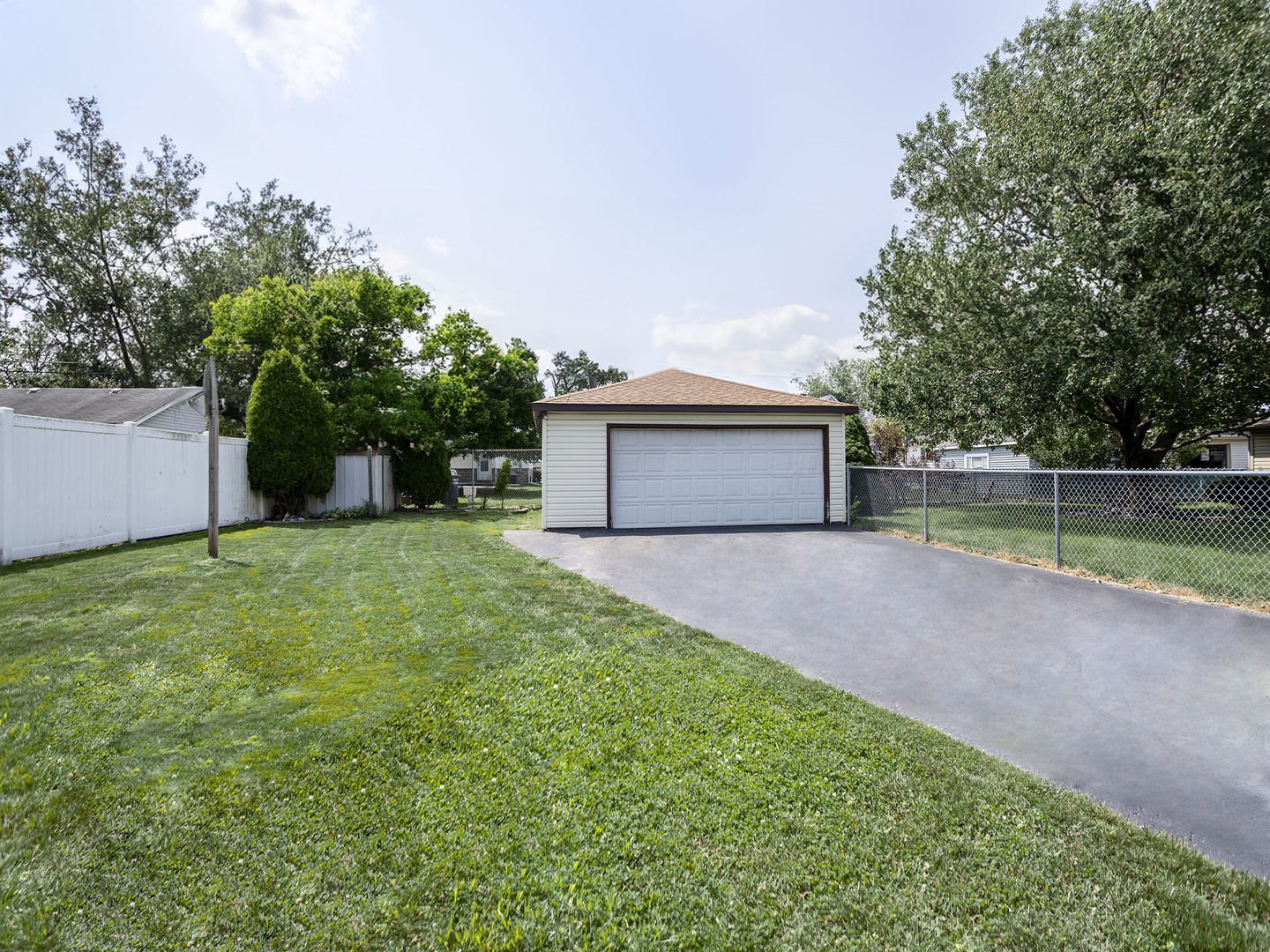 17836 Wildwood Avenue Lansing, IL 60438 - Photo 20 of 22 a front view of a house with a yard and a garage