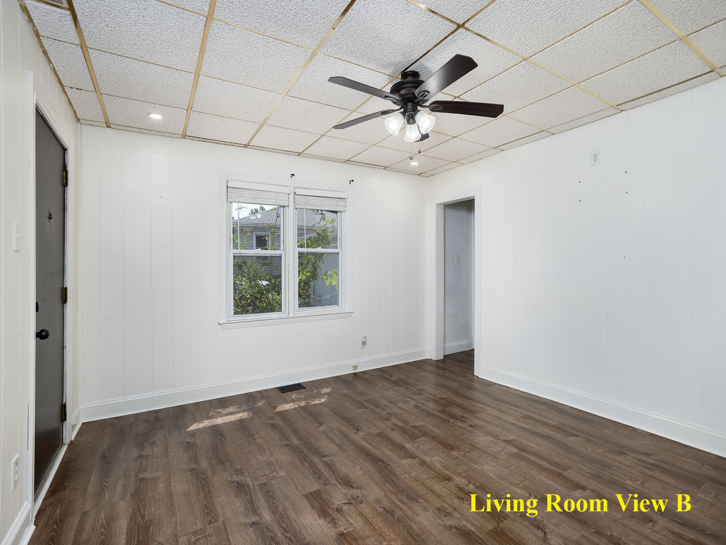 17836 Wildwood Avenue Lansing, IL 60438 - Photo 6 of 22 a view of an empty room with a window and wooden floor