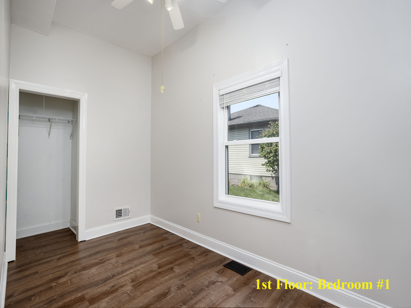 17836 Wildwood Avenue Lansing, IL 60438 - Photo 9 of 22 an empty room with wooden floor and windows