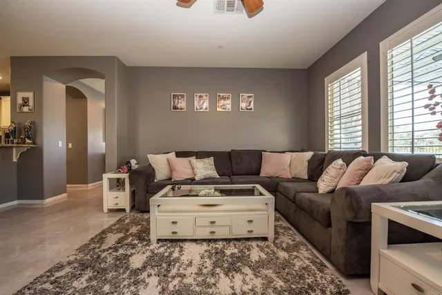 a kitchen with stainless steel appliances kitchen island granite countertop a refrigerator oven a sink dishwasher and white cabinets with wooden floor