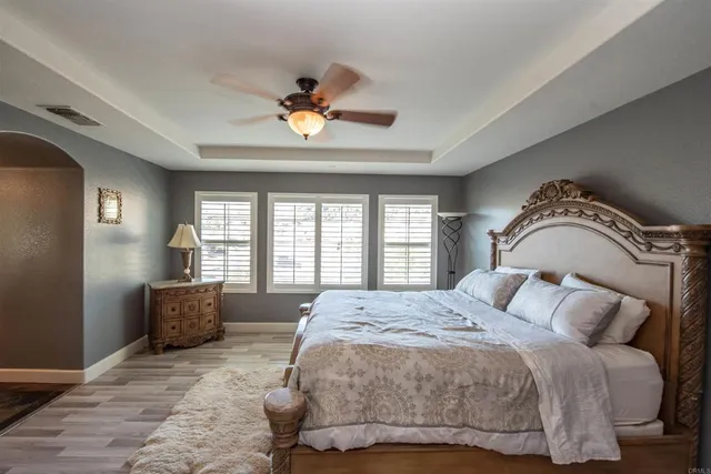 a bathroom with a granite countertop sink a mirror and a shower