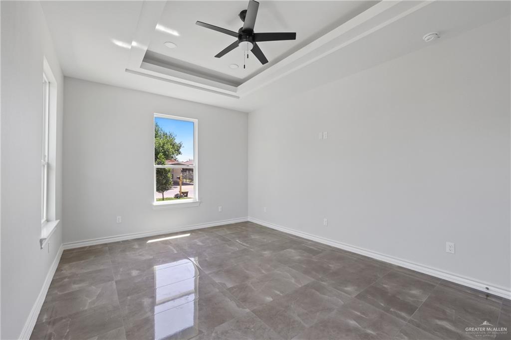 1003 Short Road San Juan, TX 78589 - Photo 12 of 20 an empty room with windows and fan