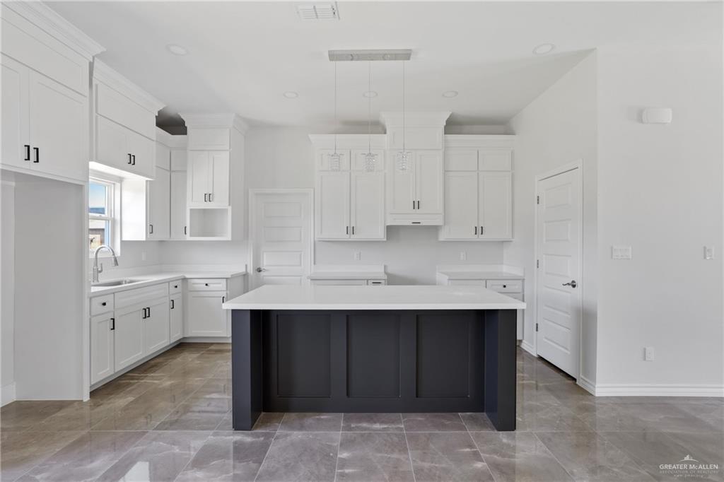 1003 Short Road San Juan, TX 78589 - Photo 16 of 20 a kitchen with sink cabinets and stove