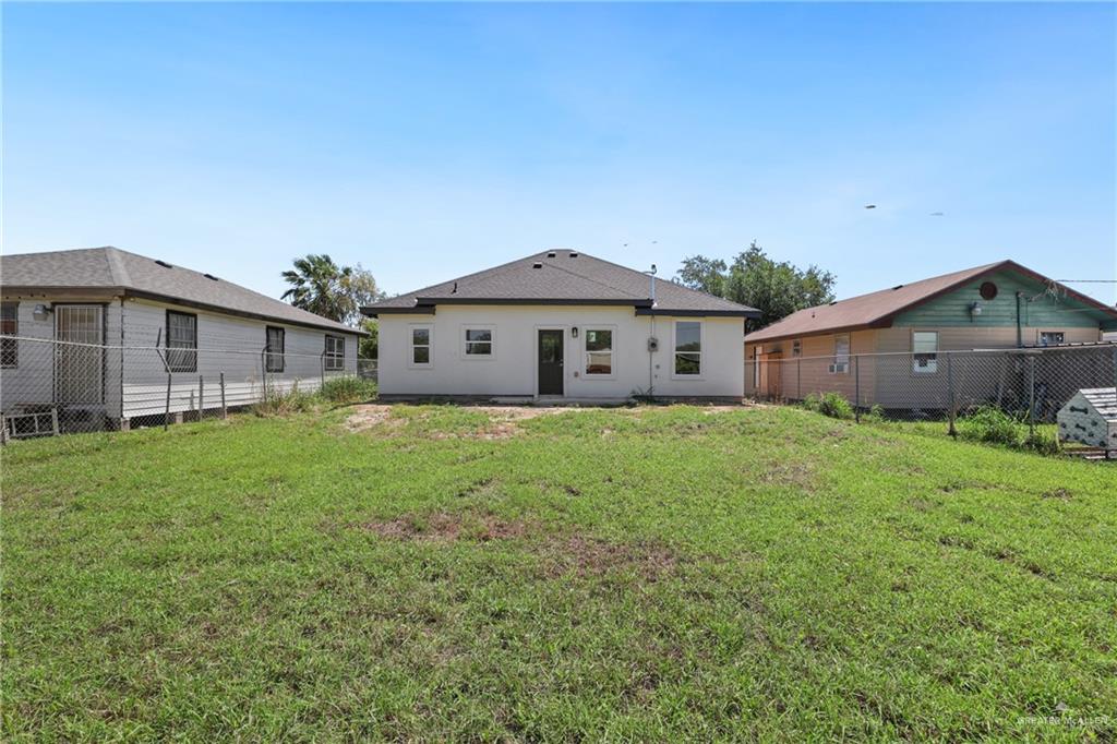 1003 Short Road San Juan, TX 78589 - Photo 19 of 20 a front view of a house with garden