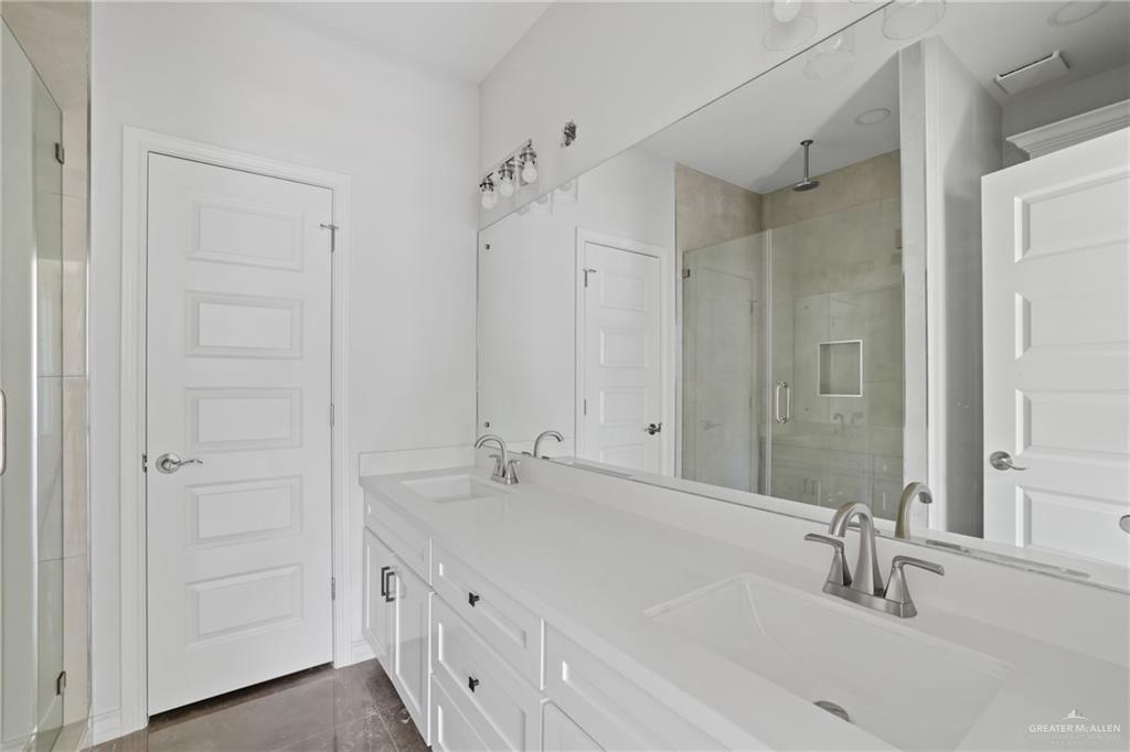 1003 Short Road San Juan, TX 78589 - Photo 10 of 20 a bathroom with double vanity sink and a mirror