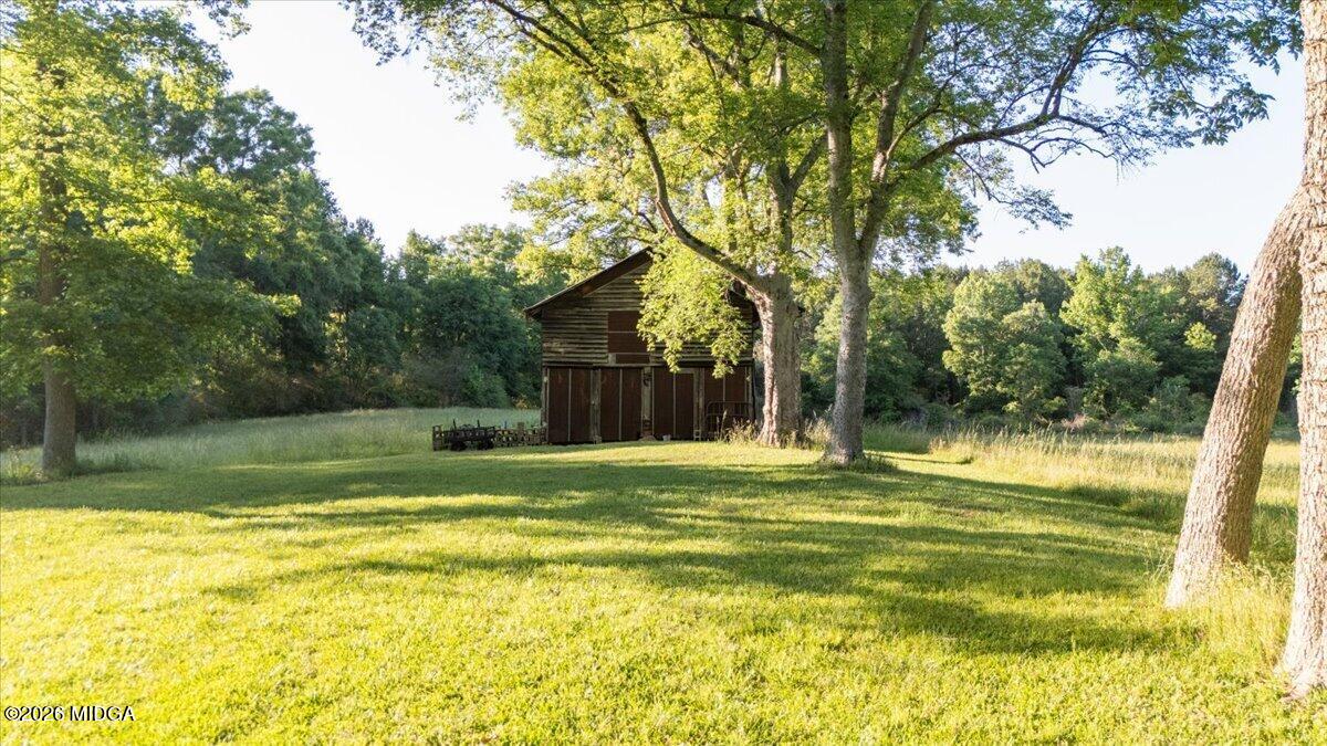 214 Howard Roberts Road Gray, GA 31032 - Photo 27 of 36 a view of a house with a big yard and large trees
