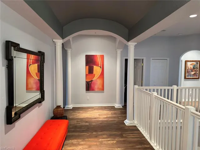 a view of hallway with livingroom and stairs