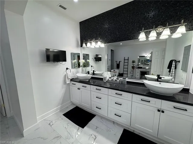a bathroom with a double vanity sink and a mirror