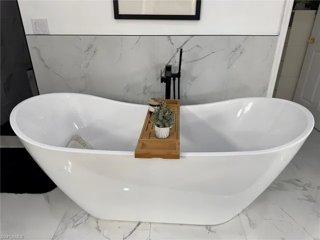 a white bath tub sitting in a bathroom