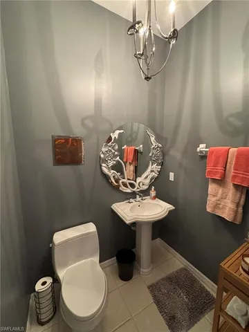 a bathroom with a toilet a sink and a mirror