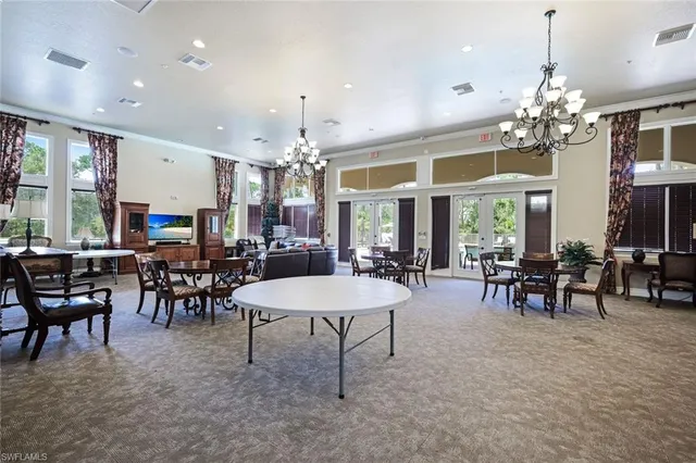 a view of a dining room with furniture and chandelier