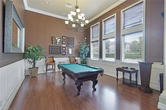 a living room with furniture a potted plant and a large window