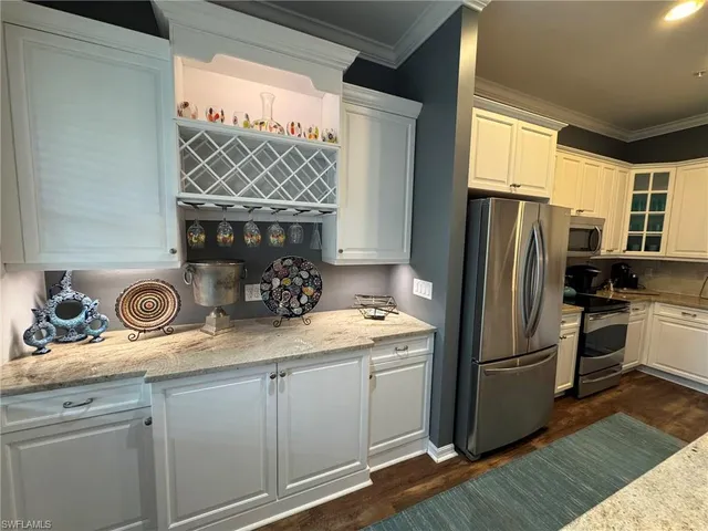 a kitchen with a refrigerator and a sink