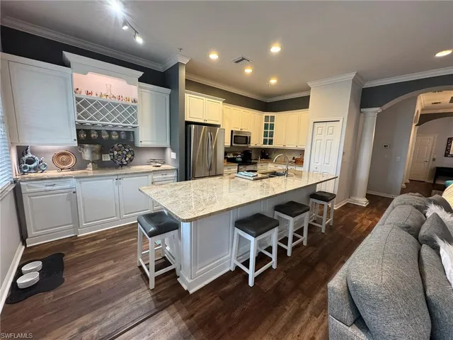 a kitchen with counter top space a sink appliances and cabinets