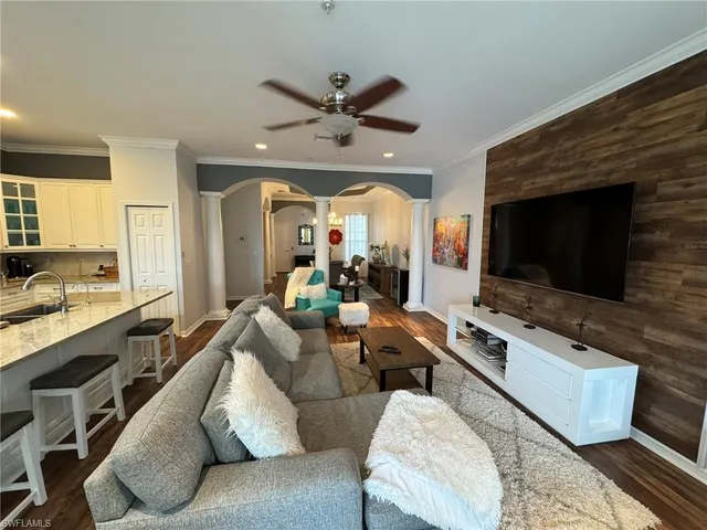 a living room with furniture flat screen tv and a fireplace