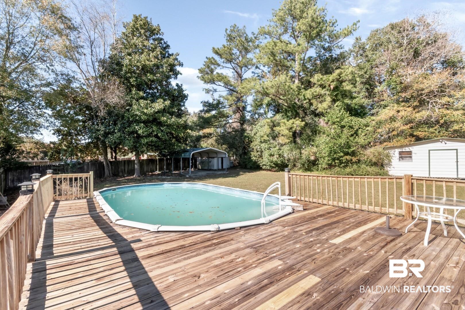 8304 Champlain Circle Mobile, AL 36695 - Photo 32 of 46 View of swimming pool featuring a deck and a lawn
