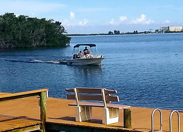 a front view of a multi story residential apartment building with yard and green space