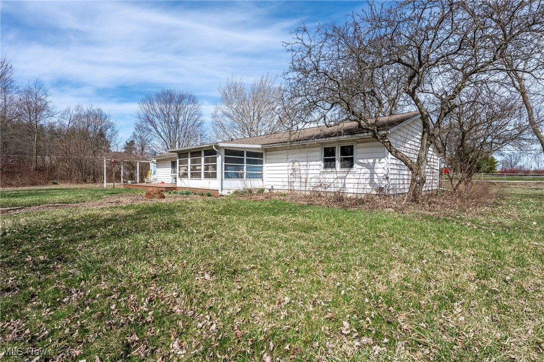 4790 Paradise Road Seville, OH 44273 - Photo 5 of 45 Back of house with a sunroom and a yard