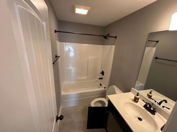 a bathroom with a bathtub and a shower
