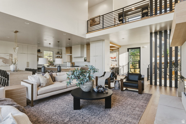 923 North Emery Lane Elk Ridge, UT 84651 - Photo 5 of 101 Open concept living space featuring a two-story ceiling, a contemporary black metal and wood-finish staircase, and light wood-finish flooring