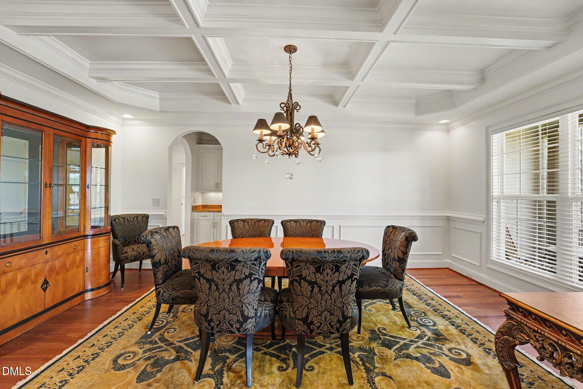 1729 Frenchwood Drive Raleigh, NC 27612 - Photo 11 of 46 a view of a dining room with furniture a chandelier and wooden floor