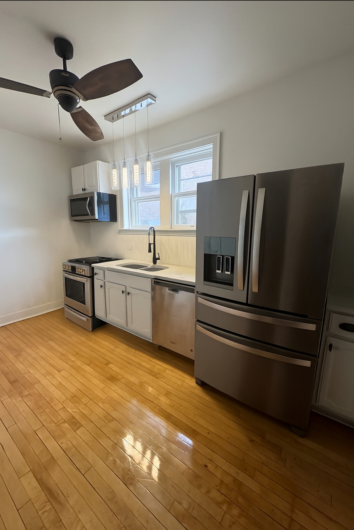 1620 Euclid Avenue, Unit 1 Berwyn, IL 60402 - Photo 6 of 10 a kitchen with stainless steel appliances granite countertop a refrigerator and a sink