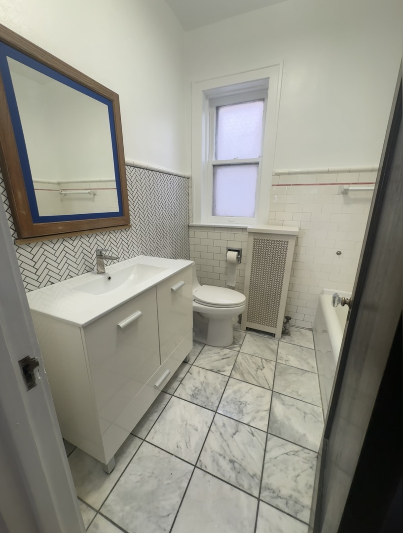 1620 Euclid Avenue, Unit 1 Berwyn, IL 60402 - Photo 8 of 10 a bathroom with a sink toilet and mirror