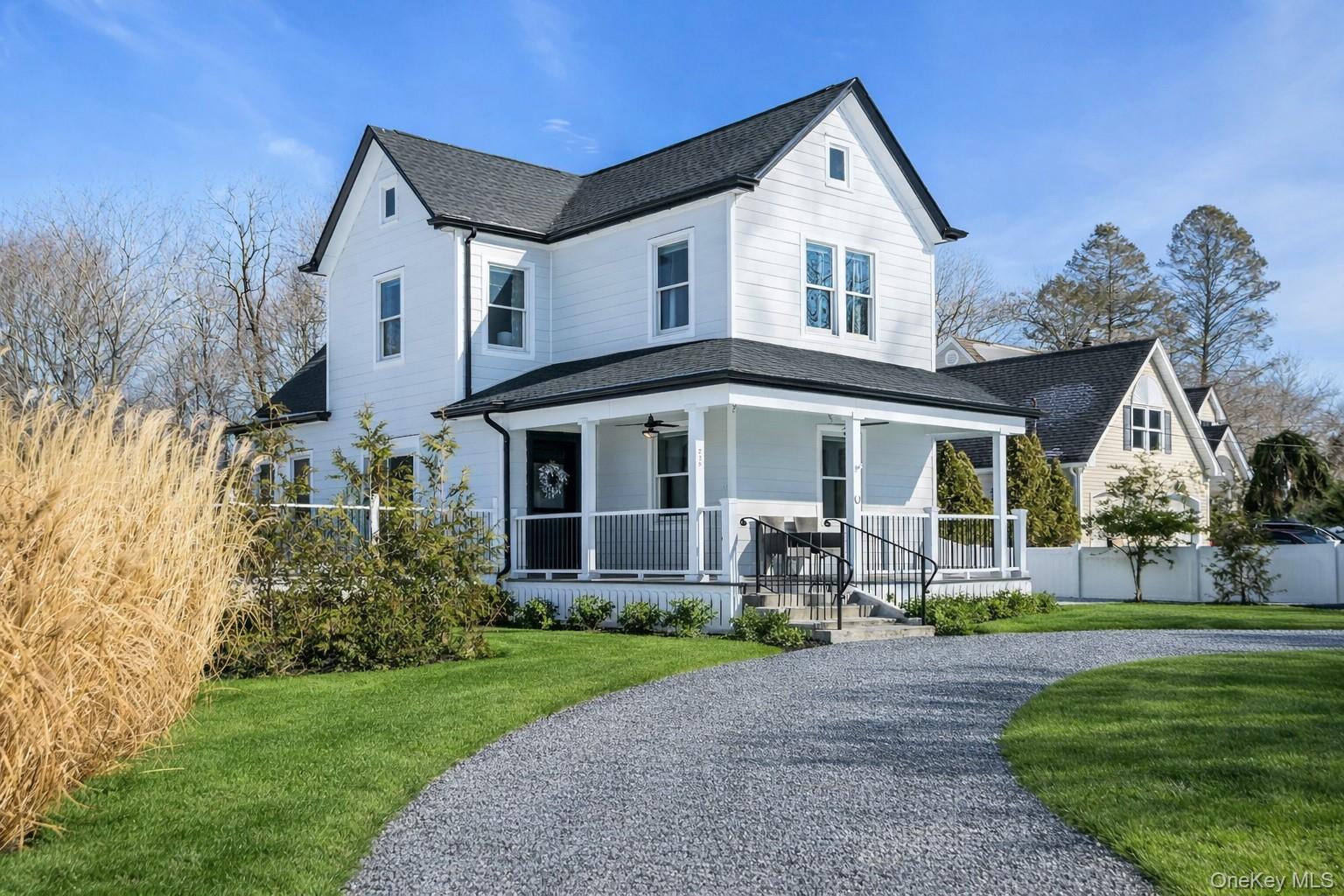 Front of completely renovated home. New blue stone gravel driveway and new landscaping.