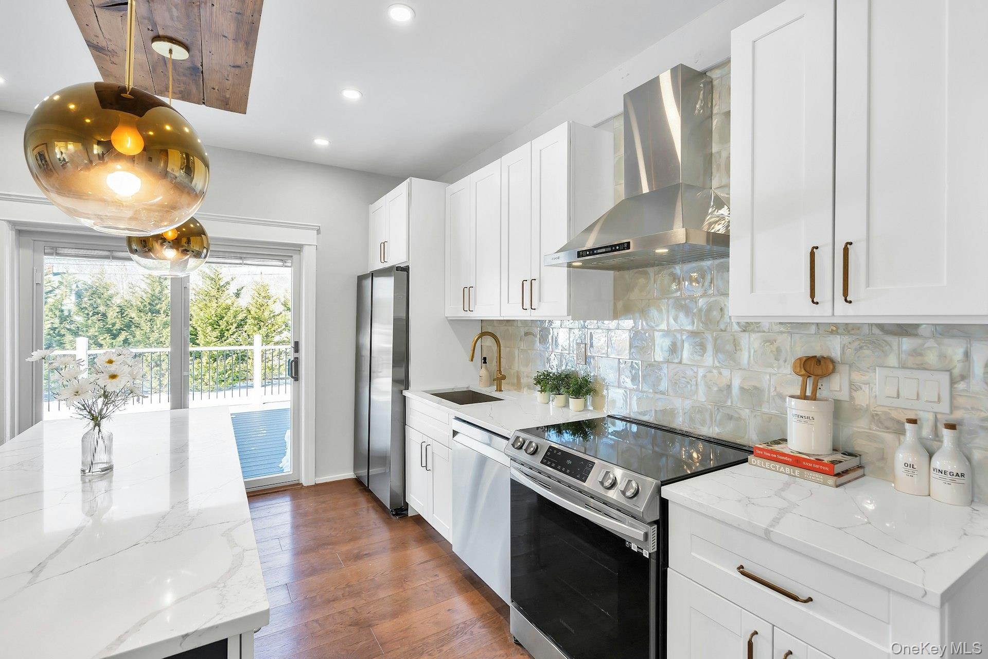 235 Cemetery Road East Marion, NY 11939 - Photo 11 of 37 Flooded with light, bright and white chef kitchen with upscale tile backsplash and stainless steel electric stove with vent.