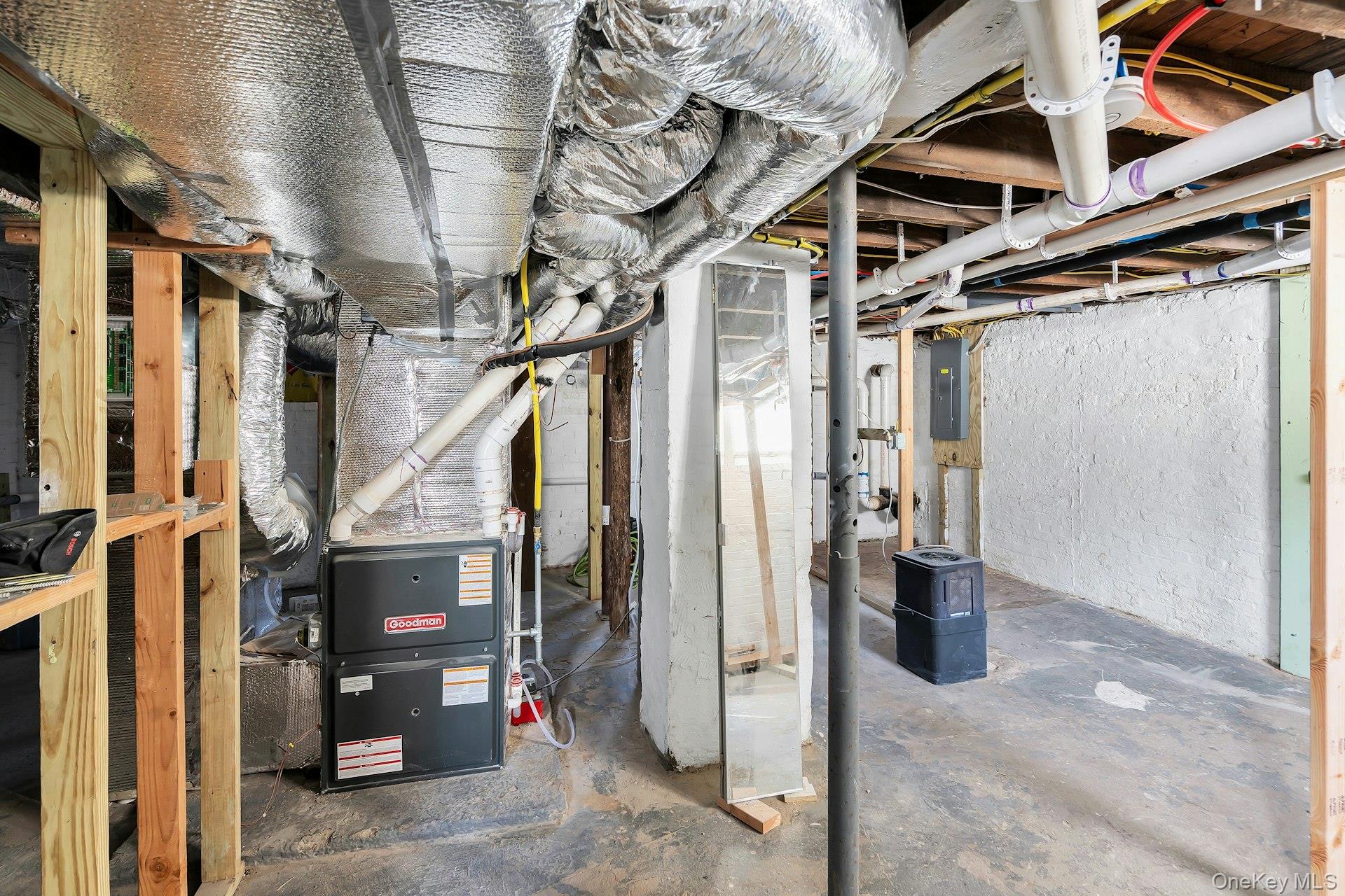 235 Cemetery Road East Marion, NY 11939 - Photo 32 of 37 Basement with all new underground 200 amp electric, furnace, water heater and hvac system with 2 zones. New Bilco doors lead to backyard. Plenty of room for storage.
