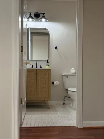 a bathroom with a toilet a sink and mirror