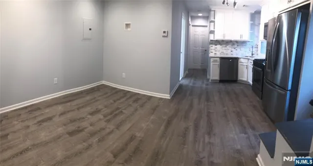 an empty room with wooden floor and a window