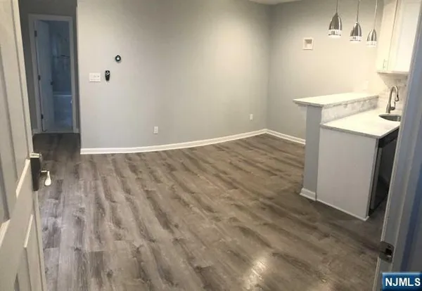 an empty room with closet and a window