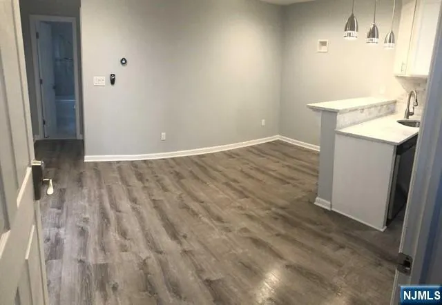 an empty room with closet and a window