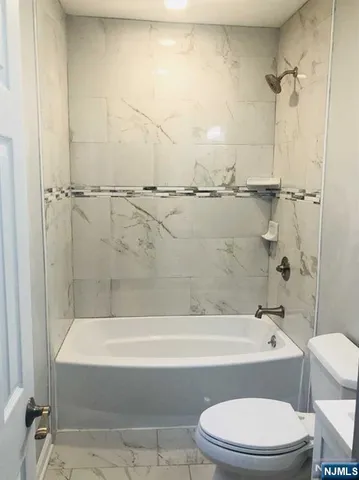 a kitchen with stainless steel appliances kitchen island granite countertop a refrigerator stove and microwave