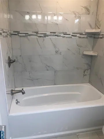 a view of a kitchen with a refrigerator a stove top oven and wooden floor
