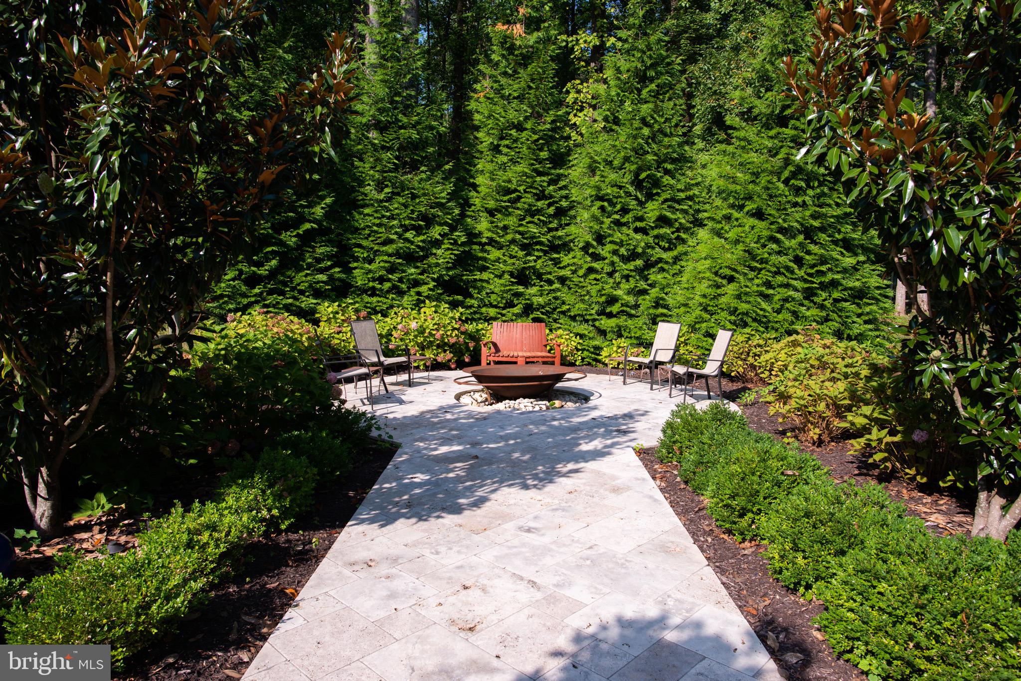10720 Stevenson Road Stevenson, MD 21153 - Photo 36 of 64 Fire pit with seating on travertine hardscaping