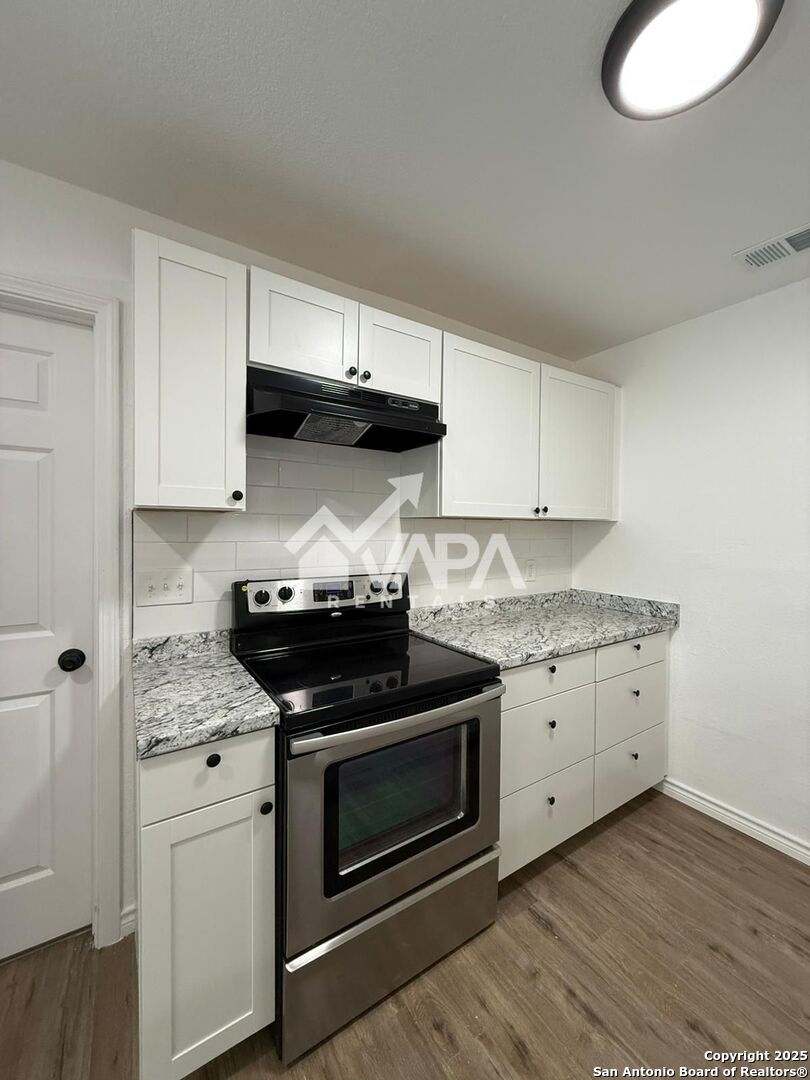 7422 Pipe Spring Street San Antonio, TX 78238 - Photo 11 of 13 a kitchen with granite countertop cabinets and stainless steel appliances