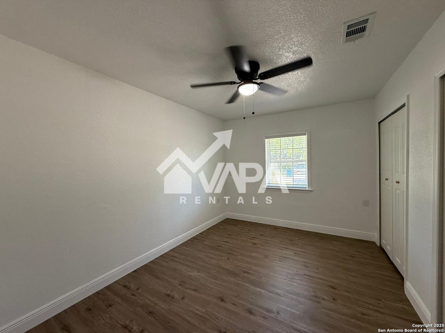 7422 Pipe Spring Street San Antonio, TX 78238 - Photo 2 of 13 an empty room with wooden floor chandelier fan and windows